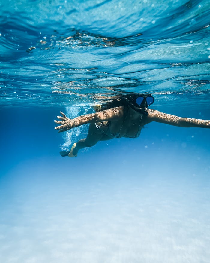 gallery-06 Woman snorkeling in clear blue waters near Honolulu, Hawaii.